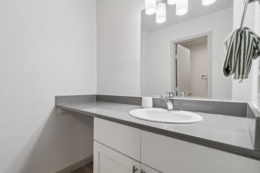A bathroom with a sink and mirror.