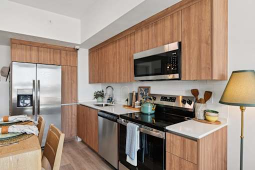 A modern kitchen with wooden cabinets and stainless steel appliances.