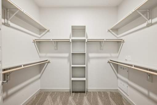 Empty white shelves in a room.