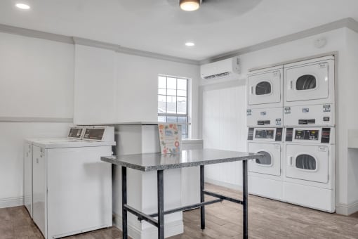 a washer and dryer in a laundry room with a table