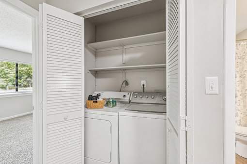 A white kitchen with a dishwasher and oven.
