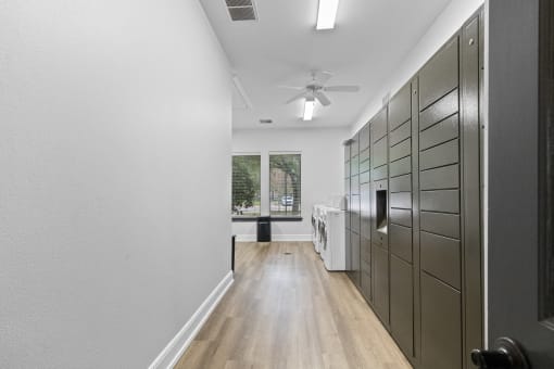 a long hallway with a closet and a ceiling fan