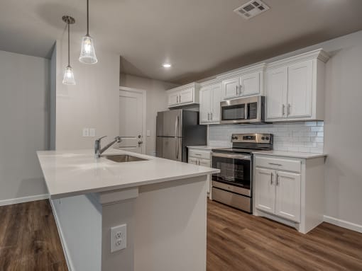 a kitchen with white cabinets and a white counter top