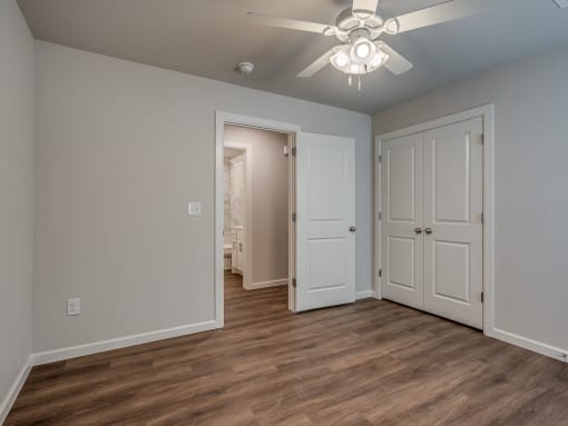 a bedroom with a ceiling fan