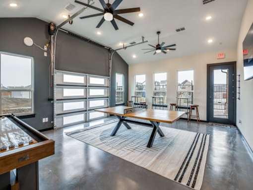A room with a pool table and a view of the outside.