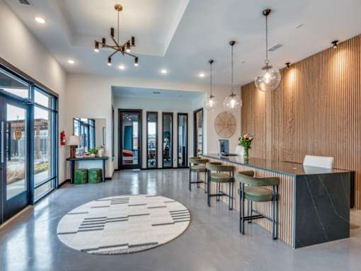 A modern lobby with a reception desk and chairs.
