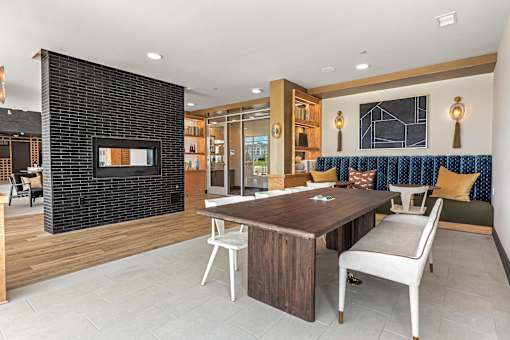 A modern living room with a fireplace and a dining table.