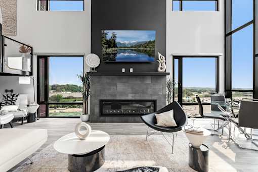 A modern living room with a fireplace and a flat screen TV.