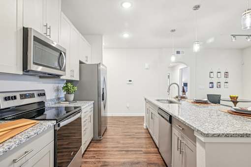 A kitchen with a stove top oven and a microwave above it.