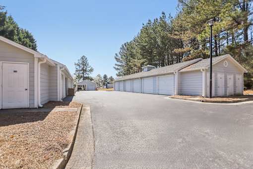 A row of white mobile homes with a clear blue sky above.