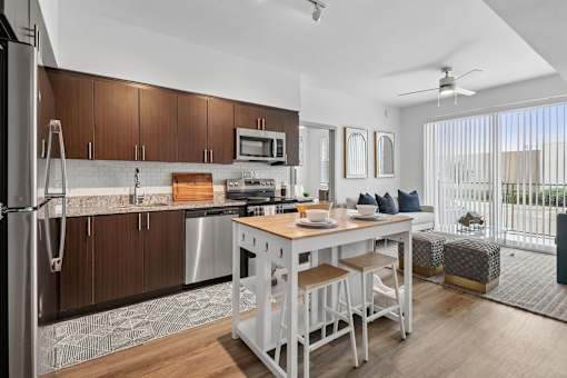 A modern kitchen with a dining table and chairs.