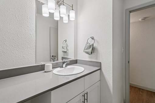 A bathroom with a sink and mirror.