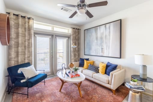 a living room with a white couch and a blue chair
