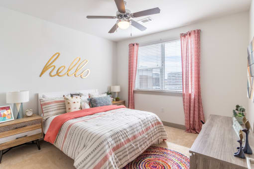 a bedroom with a bed and a ceiling fan