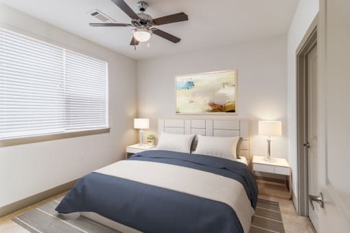 a bedroom with a large bed and a ceiling fan
