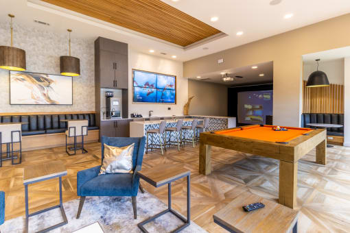 a games room with a pool table and bar