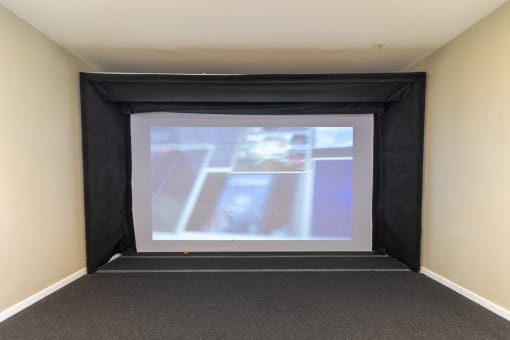 a large projection screen in a room with a carpeted floor