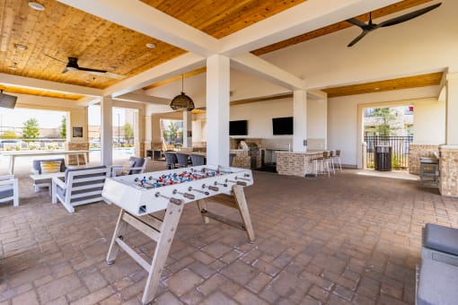 a large covered patio with a foosball table