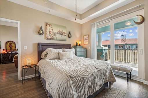 A bedroom with a large bed and a view of the city.