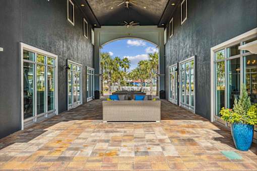 A patio with a tiled floor and a blue planter.