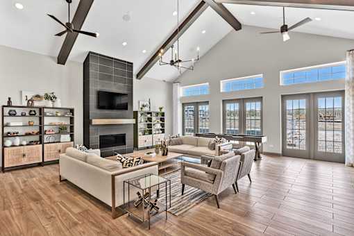 A modern living room with a fireplace and a glass table.