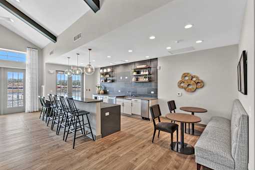 A modern kitchen with a dining table and chairs.