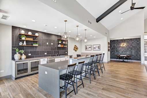 A modern kitchen with a large island and wooden floors.