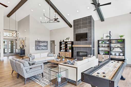 A modern living room with a pool table and a fireplace.