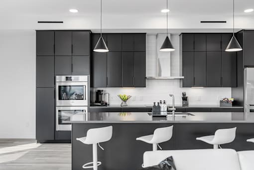 A modern kitchen with a black and white color scheme.