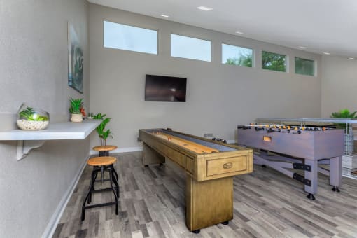 a games room with a foosball table and a ping pong table