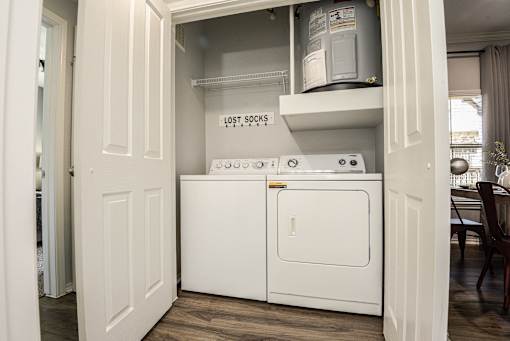 a washer and dryer in a laundry room with a door open