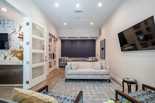 A modern bedroom with a large bed and a TV mounted on the wall.