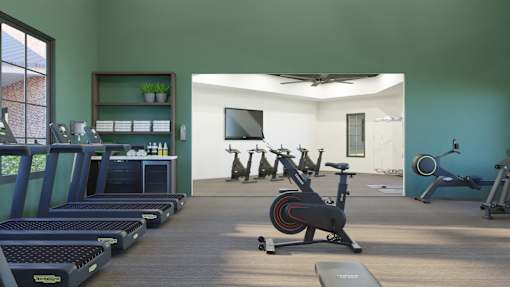 A room with exercise equipment and a television.