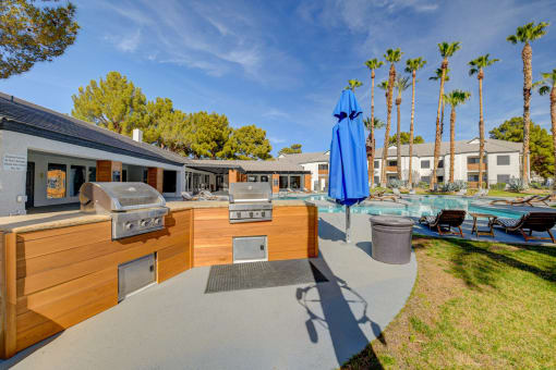 a backyard with an outdoor kitchen and pool