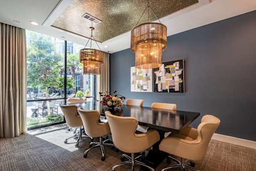 A dining room with a table and chairs.