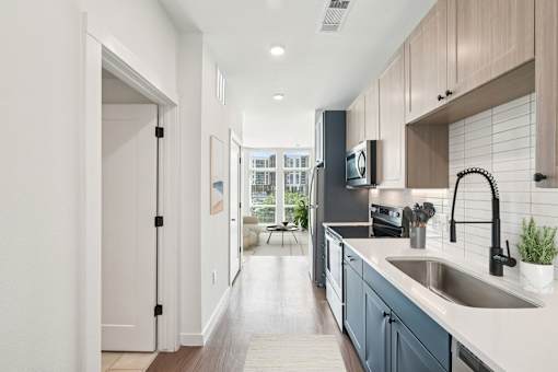 A modern kitchen with a sink and a refrigerator.
