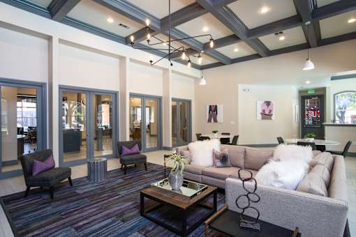 A living room with a grey couch and a coffee table.