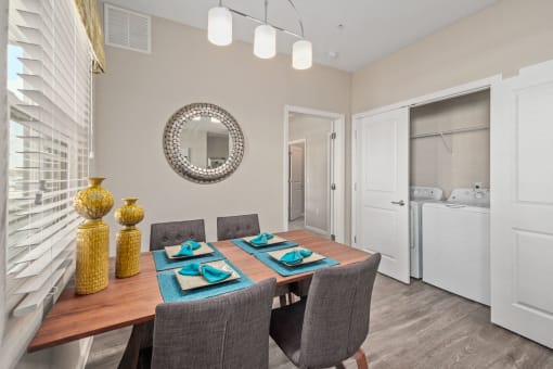 a dining room with a table and chairs and a mirror