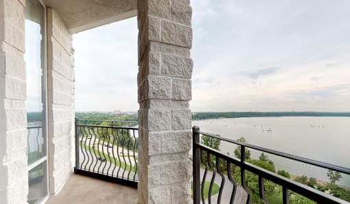 A balcony with a view of a lake and boats.