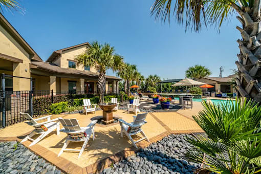 A poolside area with chairs and a fountain.