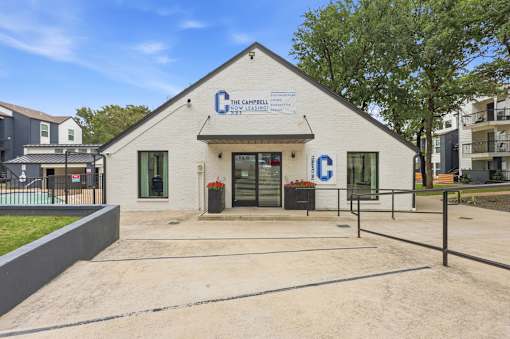 The Campbeltown Community Centre is a white building with a blue sign on the front.