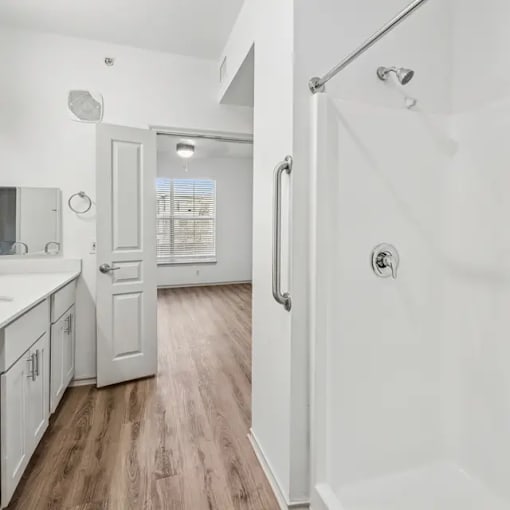 A white bathroom with a walk in shower.