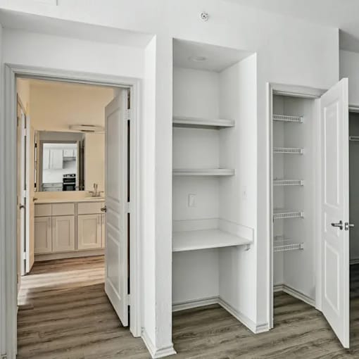 A kitchen with a white fridge and a white door.