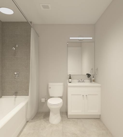 A white toilet and sink in a bathroom.