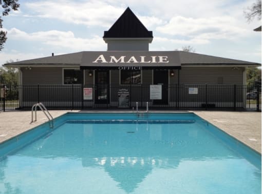 a swimming pool in front of the amalie office building