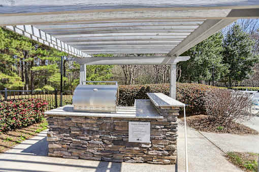 A stone structure with a metal roof and a sign on it.