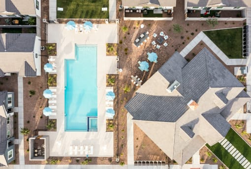 arial view of a house with a swimming pool and umbrellas
