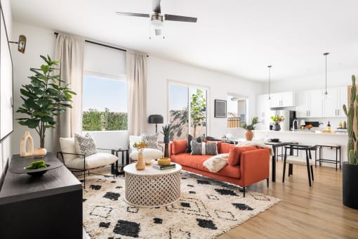 a living room with an orange couch and a dining room table