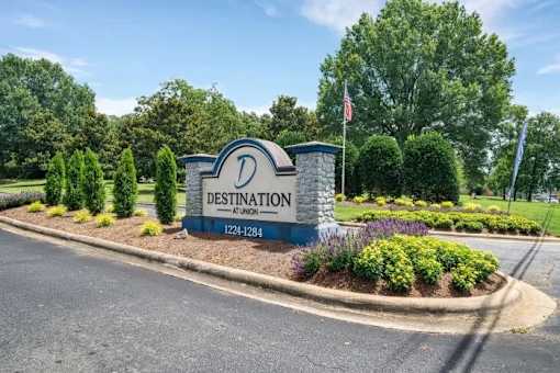 A sign for Destination at Union with a phone number and a flag.