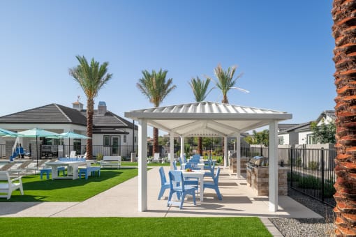 a patio with tables and chairs and a gazebo